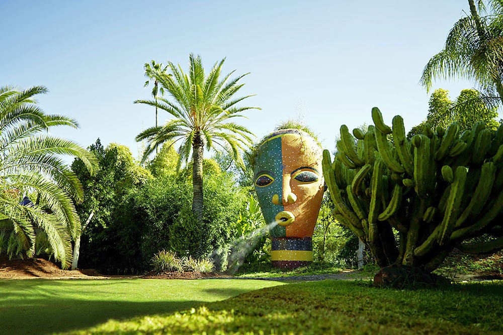 Sculpture standing among plants in the ANIMA garden near Marrakech