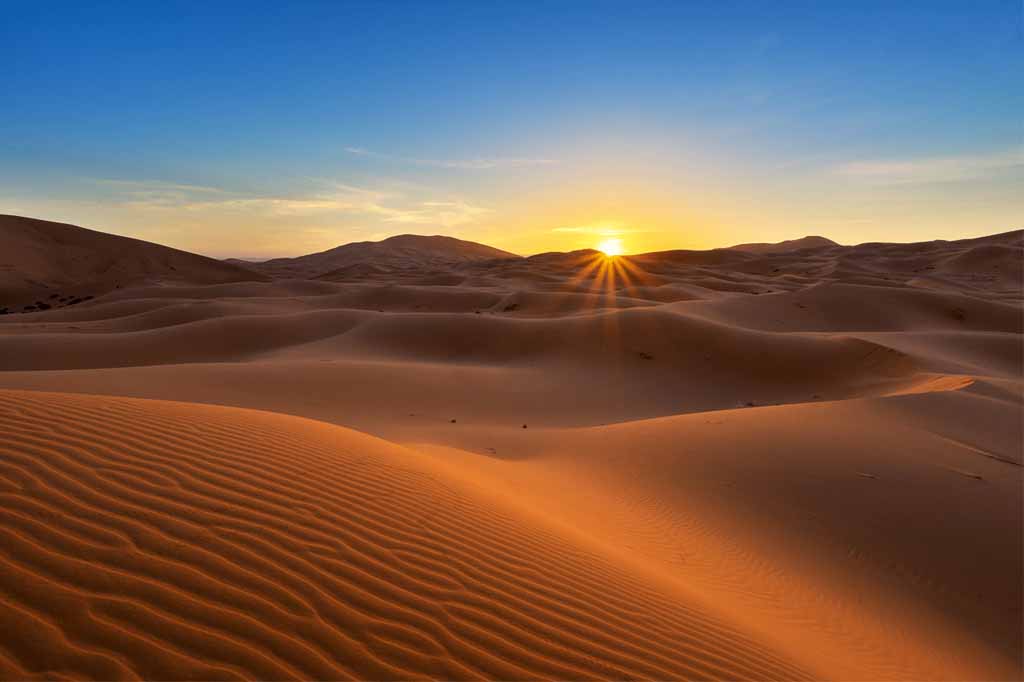 Luxury tented desert camp on the dunes of Erg Chebbi at dusk