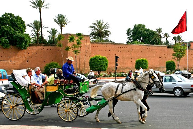 Family riding a horse-drawn carriage along the red ramparts of Marrakech