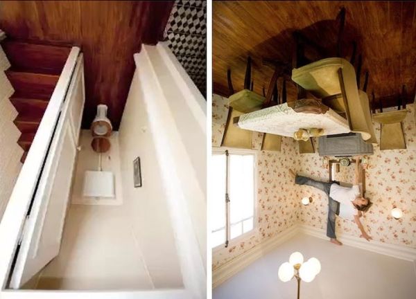 Inside the upside-down house: stairs, furniture and a lamp fixed to the ceiling
